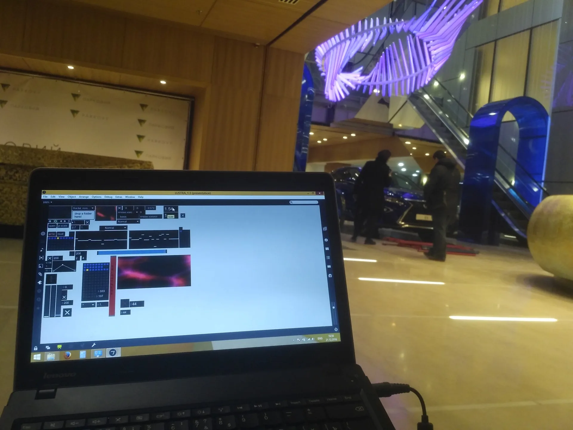 Max/MSP control patch running on a laptop with the light installation visible behind it.